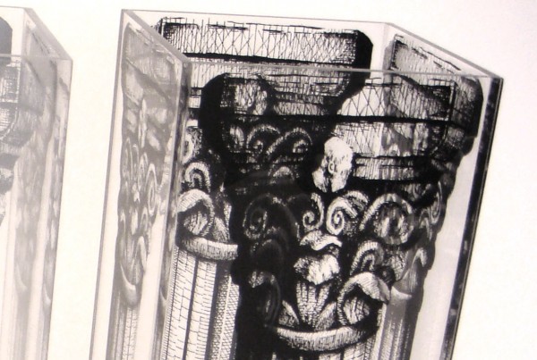 Close up of Series of Acrylic Lucite umbrella holders featuring silkscreen of hand drawn pillar