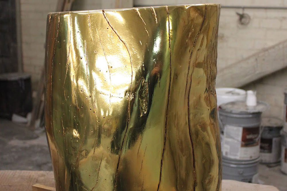 Gold metal sprayed tree stump side table